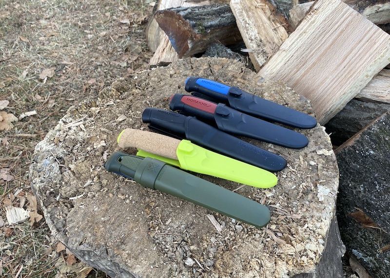 These five knives: the Basic, the Morakniv Pro, the Morakniv Companion, and others, are headed into the wilds of Manitoba this summer with a crew of Scouts. And at these price points, they're ideal blades for Scouts who are hell on steel.