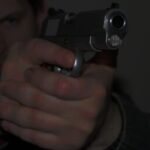 Picture of a person holding a pistol in a defensive position