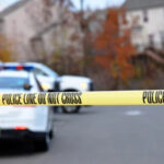 Police Cars outside of a home with police tape up