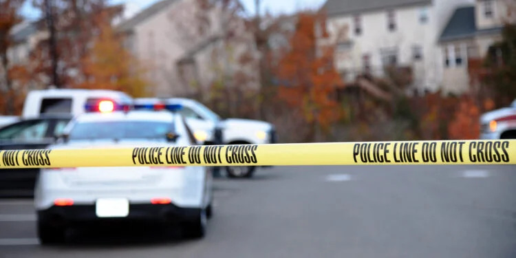 Police Cars outside of a home with police tape up