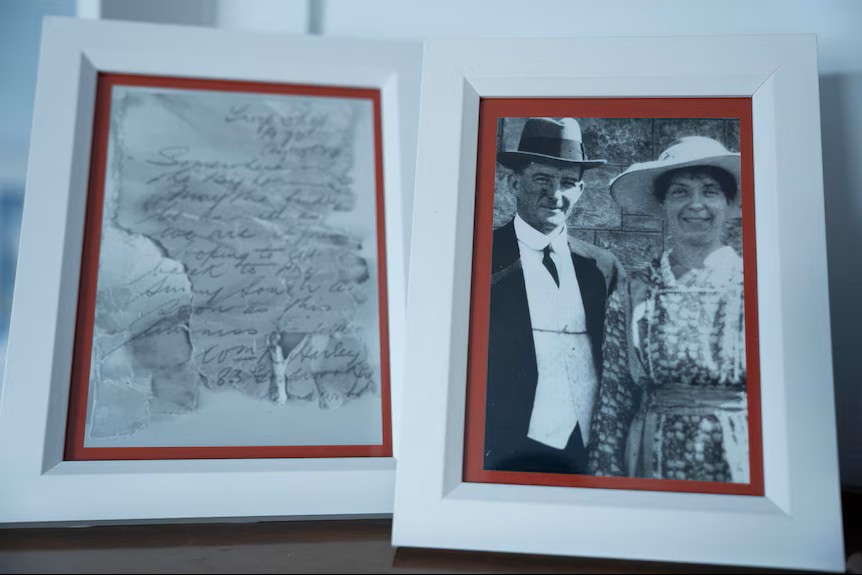 A photo copy of a torn up letter on the left, and a black and white photo of a couple smiling on the right