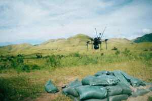 A U.S. Marine with Battalion Landing Team 3/6, 22nd Marine Expeditionary Unit (Special Operations Capable), launches a Neros Archer first-person view drone during an attack drone training final exercise on Camp Santiago, Puerto Rico, Nov. 25, 2025. 22nd MEU(SOC) Marines are being trained and certified by 2nd Marine Division and the Marine Corps Attack Drone Team on first-person view drone systems to enhance combat readiness. U.S. military forces are deployed to the Caribbean in support of the U.S. Southern Command mission, Department of War-directed operations, and the president's priorities to disrupt illicit drug trafficking and protect the homeland. (U.S. Marine Corps photo)