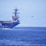 US aircraft carrier USS Abraham Lincoln and one of her escorts, the USS Spruance, enforcing the Strait of Hormuz blockade